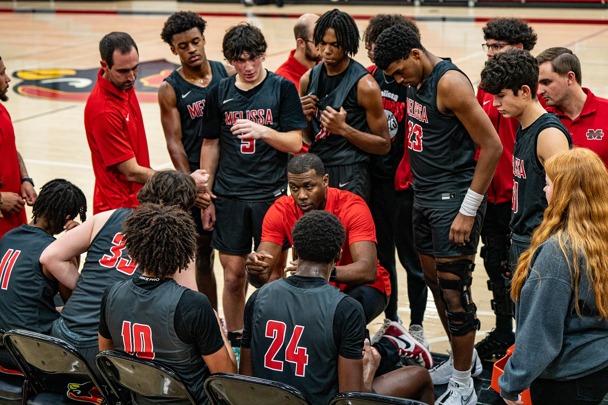 Founder coaching a basketball team during a huddle